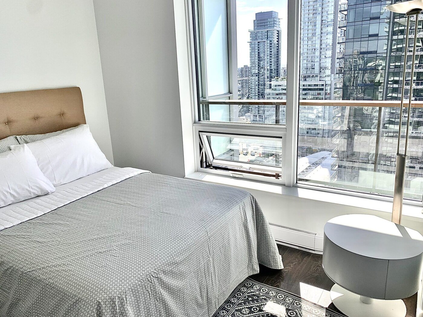 Bedroom with queen bed and city view