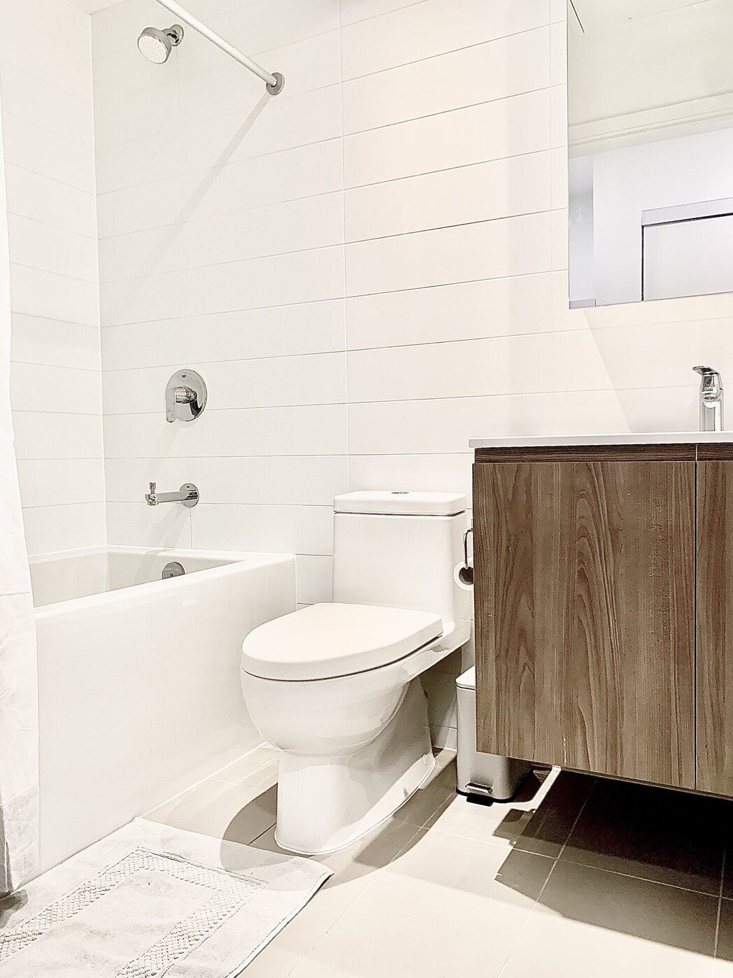 Bathroom with soaker tub and walnut vanity